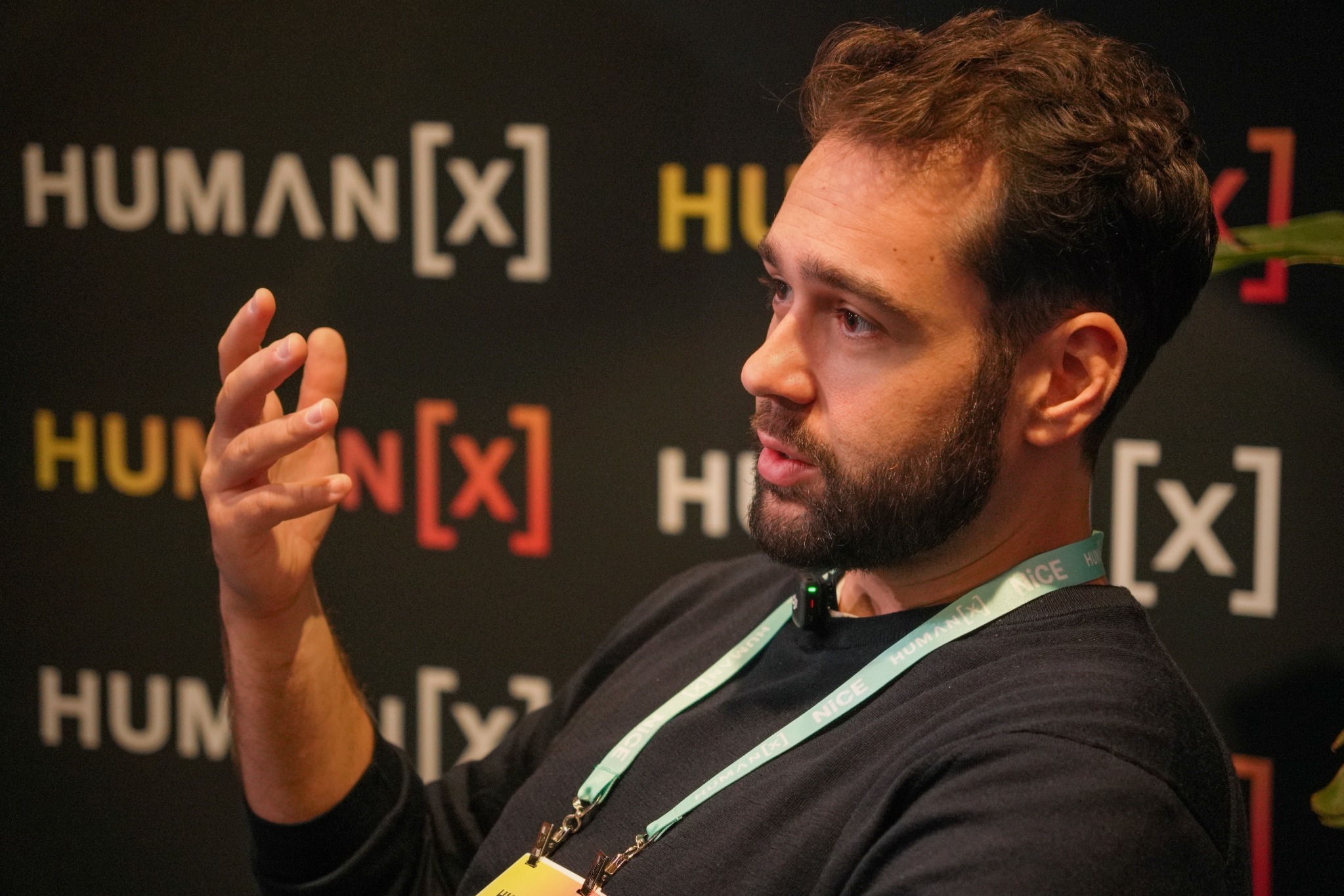 Niku Dhillon speaking and gesturing during a conversation at HumanX Amsterdam